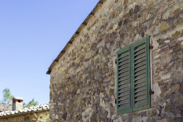 Old buildings in Tuscany on blue sky background