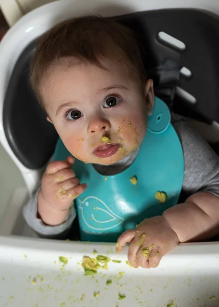 Messy Baby Boy Eating Avocado 스톡 이미지