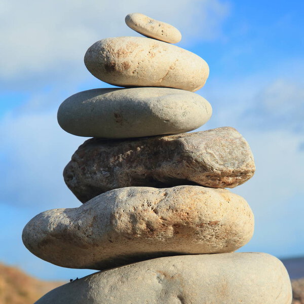 Pile of stones against cloudy sky on the Jurassic Coast