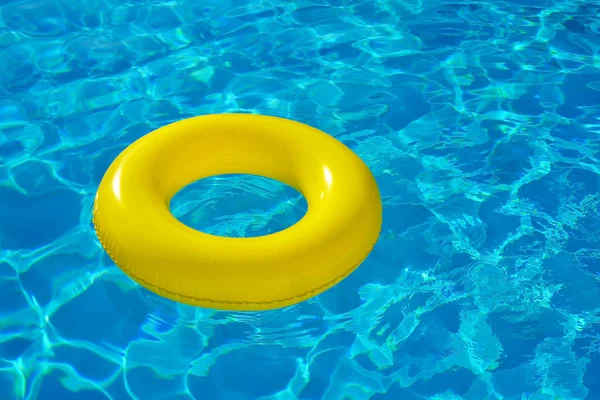 Colorful inflatable tube floating in swimming pool — Stock Photo, Image