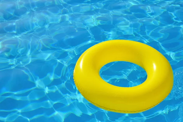 Colorful inflatable tube floating in swimming pool — Stock Photo, Image