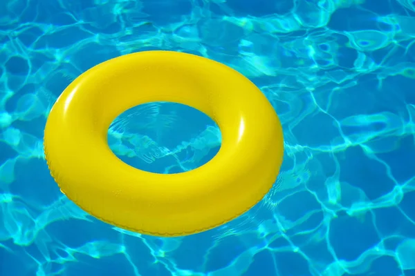 Colorful inflatable tube floating in swimming pool — Stock Photo, Image