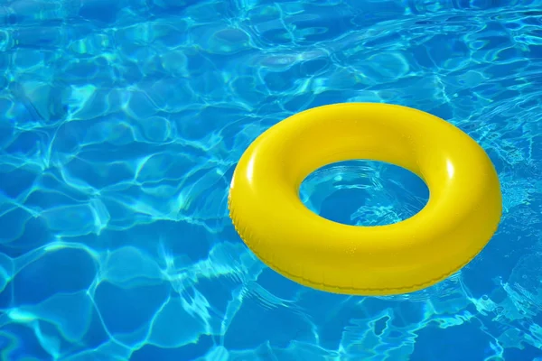 Colorful inflatable tube floating in swimming pool — Stock Photo, Image