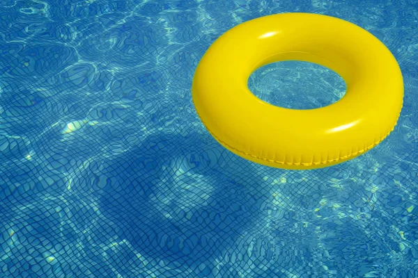 Colorful inflatable tube floating in swimming pool — Stock Photo, Image