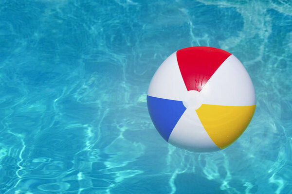 Colorful inflatable ball floating in swimming pool