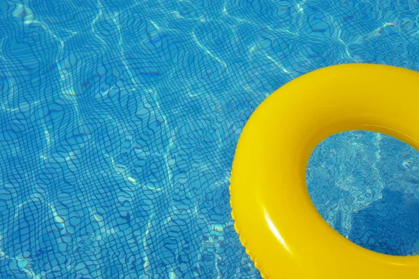 Colorful inflatable tube floating in swimming pool, summer vacation concept