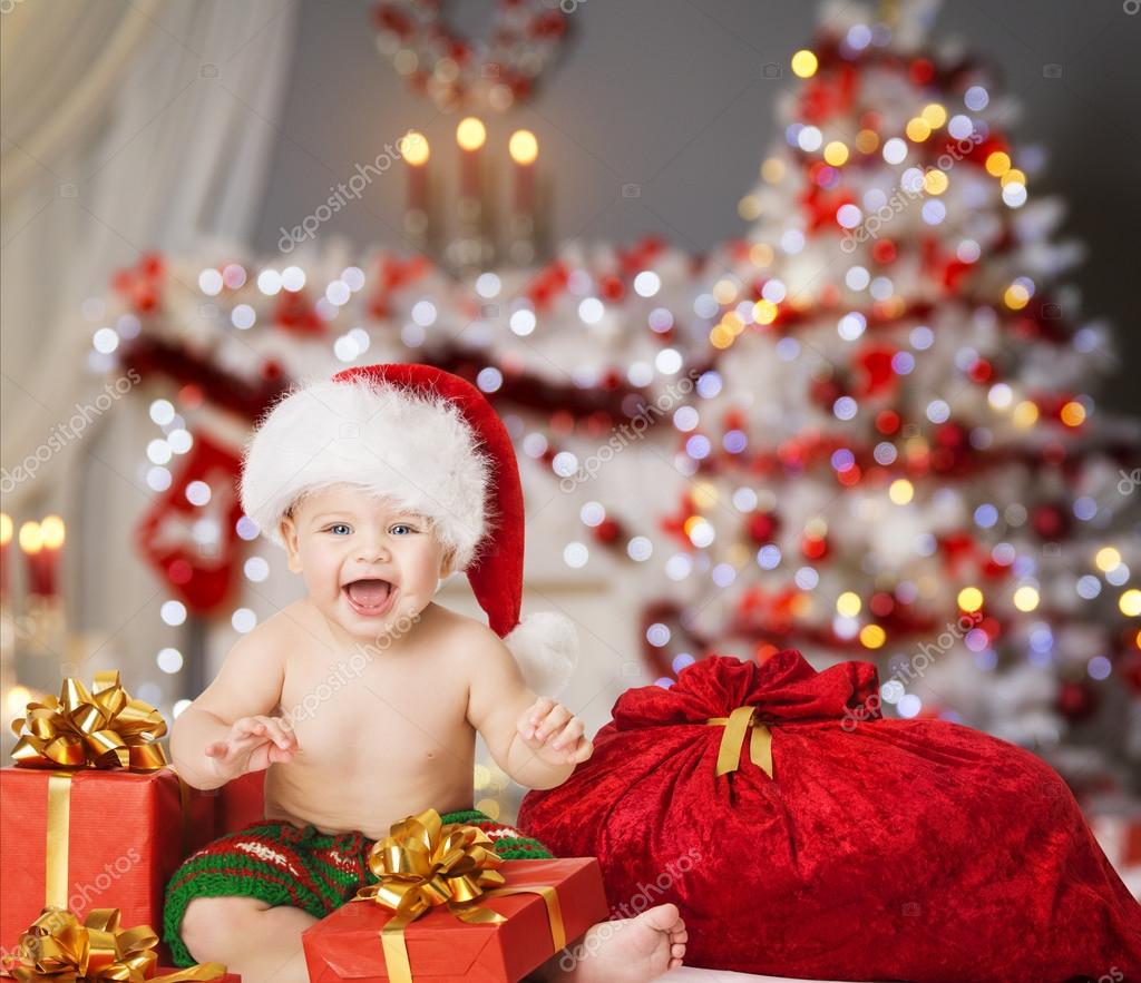 Bebé de Navidad en Santa Sombrero, Niño con regalo de regalo de