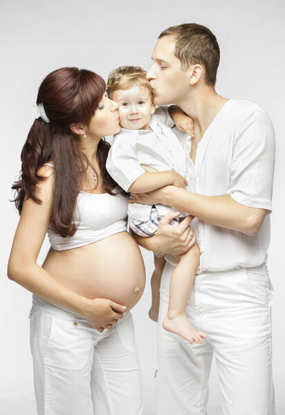 Happy Family Kiss Child, Pregnant Mother Father Kissing Kid Boy, Parents and Baby 