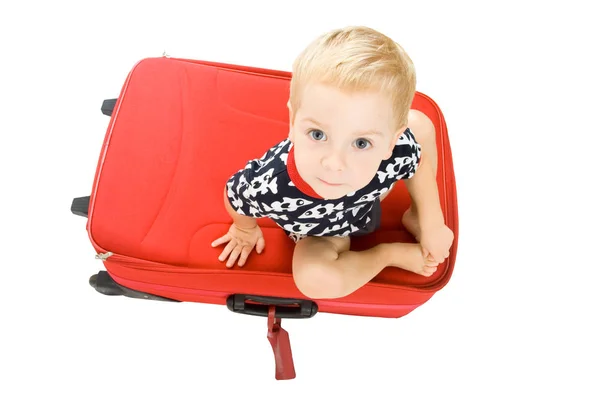 Ребенок и чемодан, ребенок, сидящий на багаже, ребенок в белой изоляции — стоковое фото