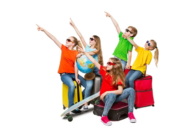 Детская группа, указывающая направление путешествия, подростки в сапогах на туристических чемоданах, дети в белых утепленных сапогах — стоковое фото