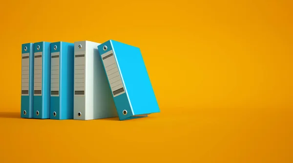 Blue and gray ring binders on a yellow background