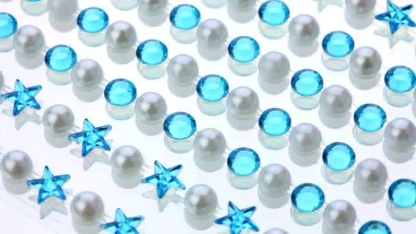 Shiny pearl and blue rhinestones spinning background — Stock Video