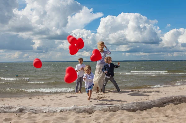 Happy family celebrating valentines day on the beach.