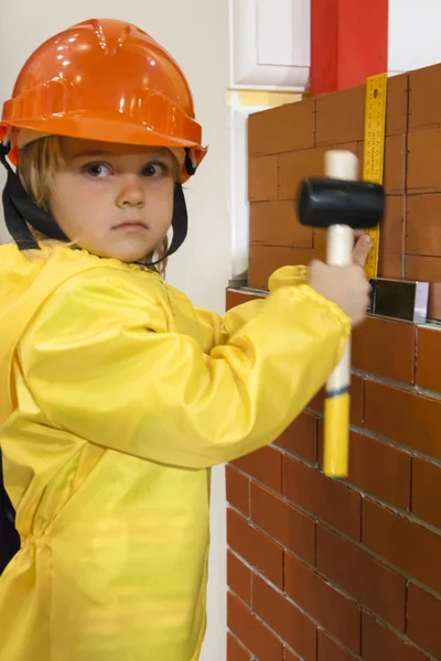 Little child builder in hardhat with hammer — Stock Photo, Image