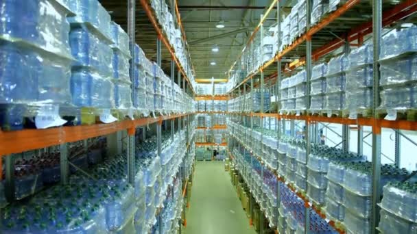 Camera moving down the shelves of pure bottled water — Stock Video