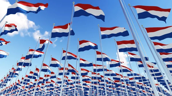 Lijst van vlaggen van Nederland wuiven in de wind tegen blauwe hemel. — Stockfoto