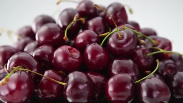 Heap of fresh cherries rotate on white background. — Stock Video