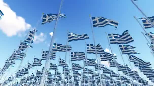 Many Greece flags on flagpoles against blue sky. — Stock Video