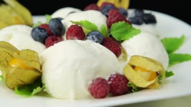 Ice cream dessert with fresh berries and mint leaves