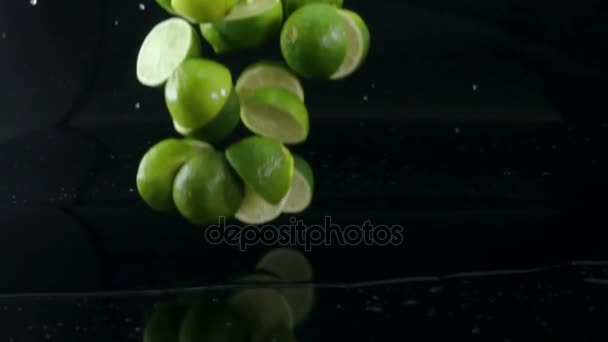 Slow motion lime halves with water falling — Stock Video