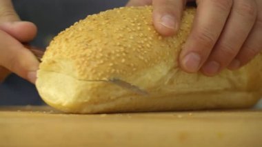 Erkek kesme buğday ekmeği sandviç, closeup hazırlamak için susam ile eller