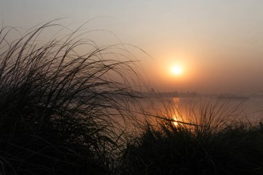 sunrise on Yamuna river in Delhi, India clipart