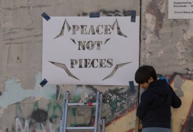 BETHELEM, PALESTINE - MAY 20, 2017:  Palestinians make graffiti on Israeli West Bank barrier in Bethlehem