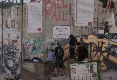 BETHELEM, PALESTINE - MAY 20, 2017:  Palestinians make graffiti on Israeli West Bank barrier in Bethlehem