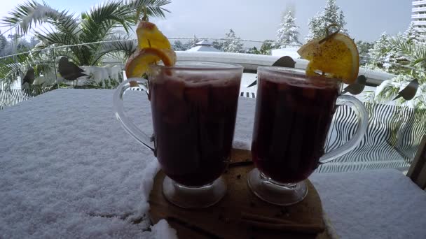 Two of mulled wine on the background of snow — Stock Video