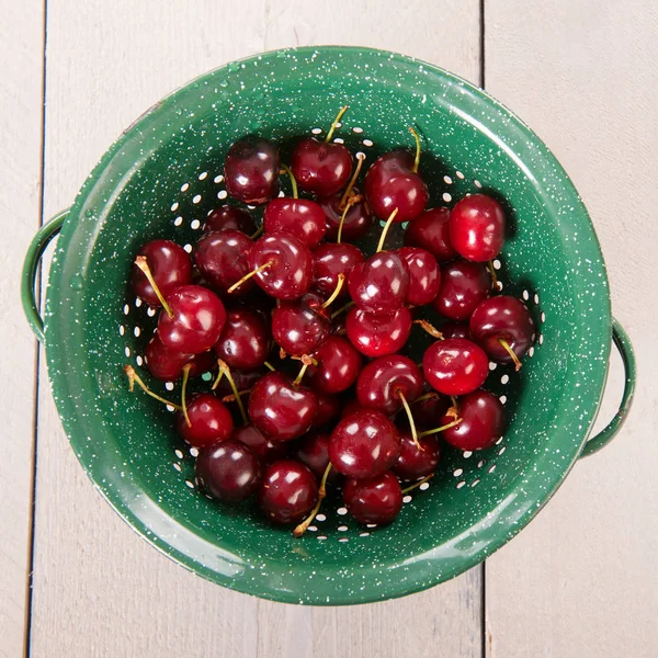 Fresh cherries in colander — Stock Photo, Image