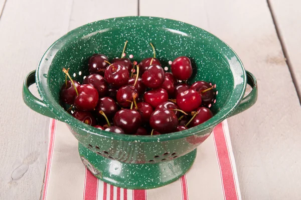 Fresh cherries in colander — Stock Photo, Image