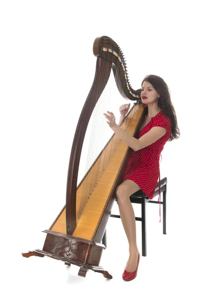 Junge Frau spielt Harfe — Stockfoto