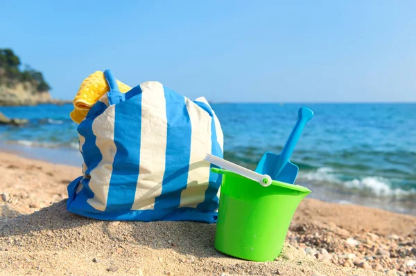 Beach bag and toys at the beach — Stock Photo, Image