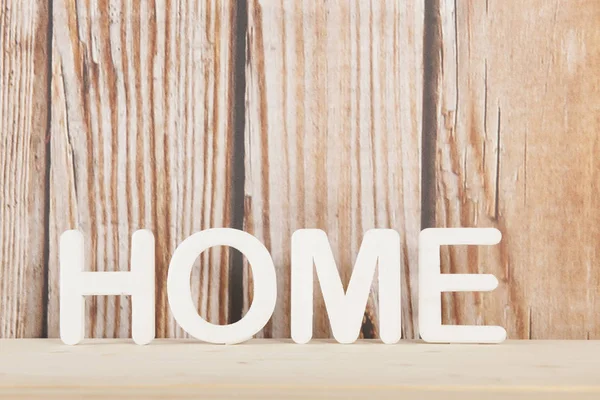 Home on wooden background — Stock Photo, Image