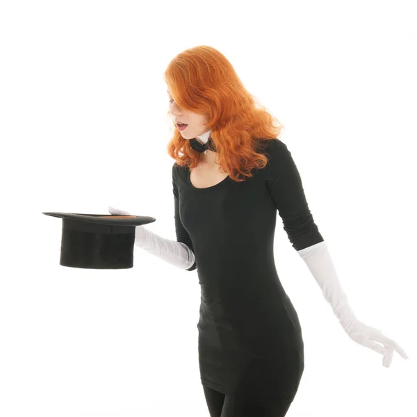 Woman conjuring with hat — Stock Photo, Image