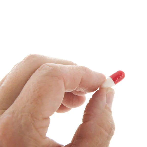 Capsules in red and white in hand — Stock Photo, Image