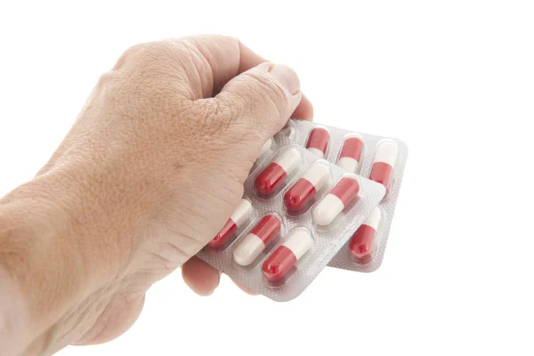 Capsules in red and white in hand — Stock Photo, Image