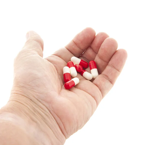 Capsules in rood en wit in de hand — Stockfoto