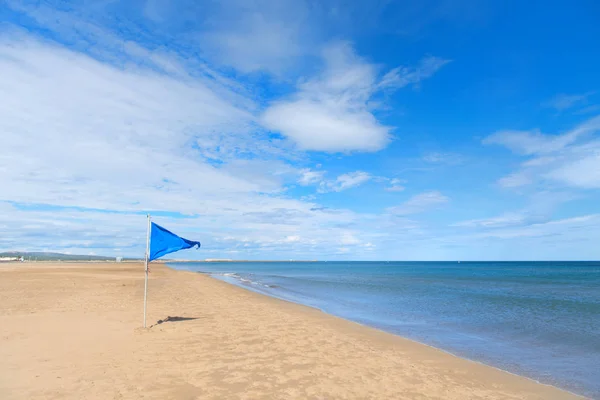 Blue flag on Gruissan plage in France — Stok fotoğraf