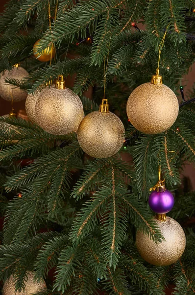 Golden bulbs on new year tree close up Royalty Free Stock Images