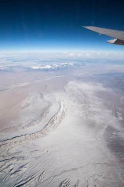 wing of airplane above desert lands