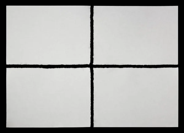 Quatro pedaços de papel rasgado sobre um fundo preto — Fotografia de Stock