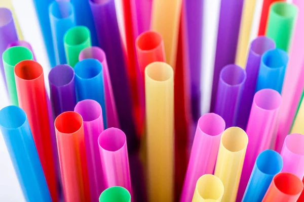 Closeup of colored drinking straws for juice and cocktails. Fresh background