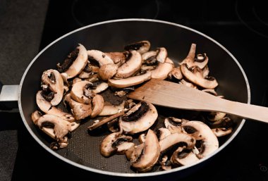 Kızartma tavasında dilimlenmiş mantar.