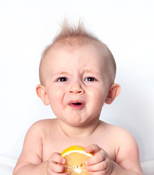 Küçük çocuk önce limonu tadacak. 