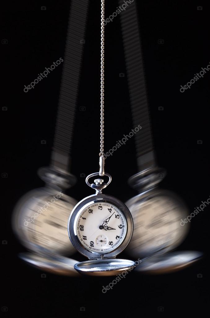 Фотообои Swinging pocket watch hypnosis on black.