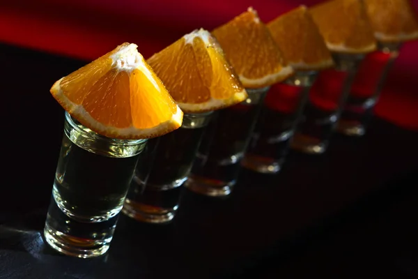 Tequila with orange on a dark background — Stock Photo, Image