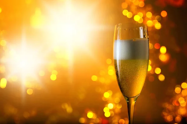 Glass of champagne on a background of Christmas  decoration — Stock Photo, Image