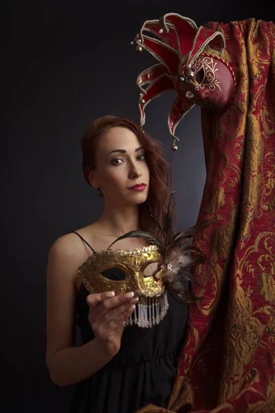 Woman in black dress with carnival masks — Stock Photo, Image