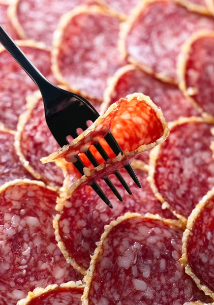 Salami slice on a fork